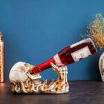 Handcrafted skull wine rack holder displaying wine bottles, perfect for gothic decor and wine enthusiasts.